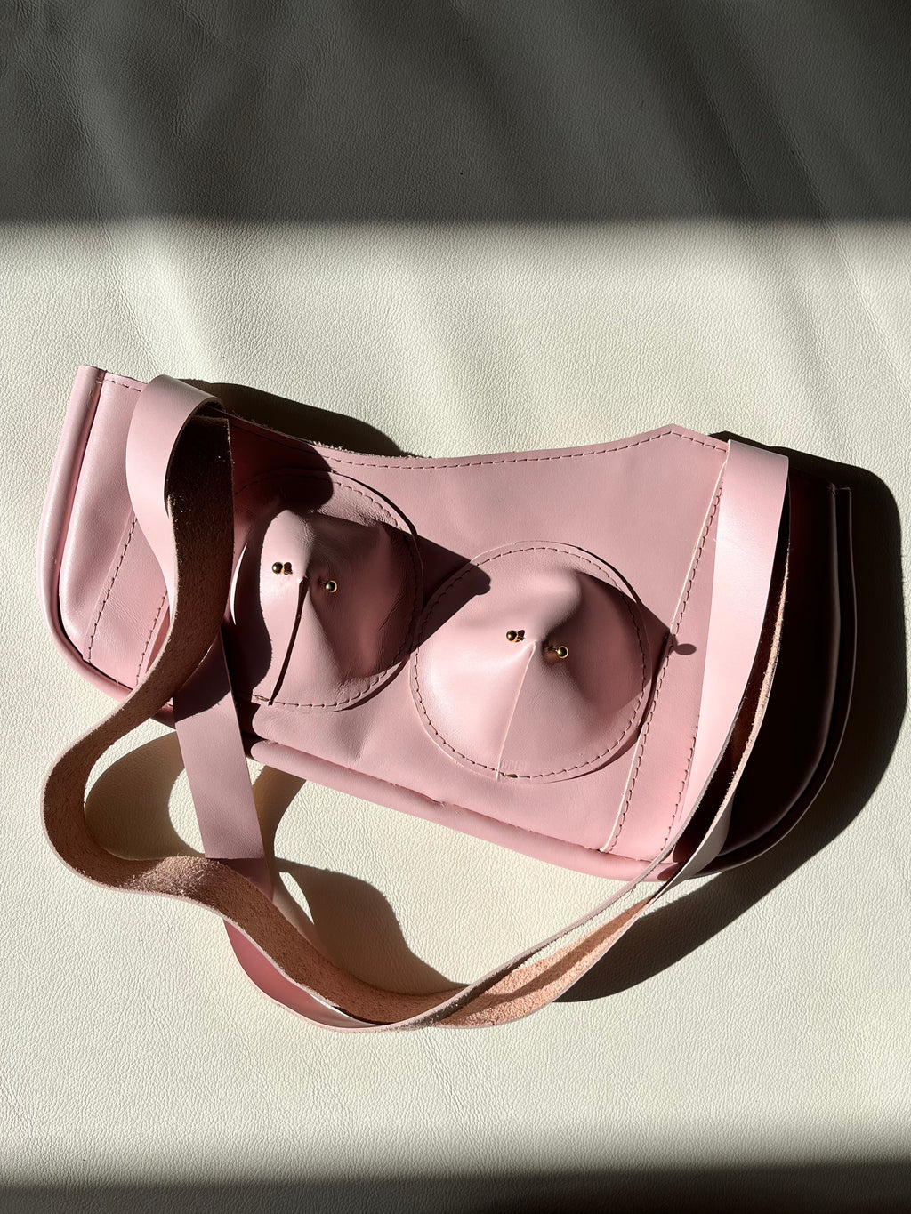 Pink pierced pair shoulder bag